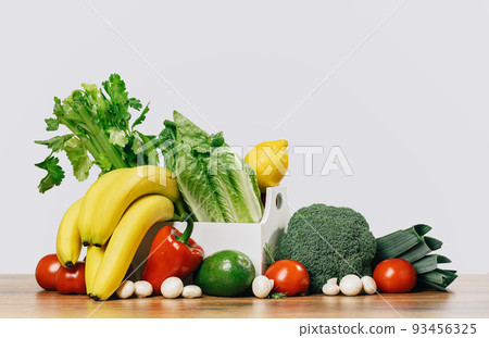 Grocery. box full of fruit and vegetables on tabletop Grocery. box full of fruit and vegetables on tabletop 93456325