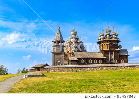 View to old monastery Kizhi Pogost, wooden Temple and Churchyard. Church of Transfiguration, bell tower in summer at sunset. Natural ecological clean island in Onega lake, Republic of Karelia, Russia 93457848