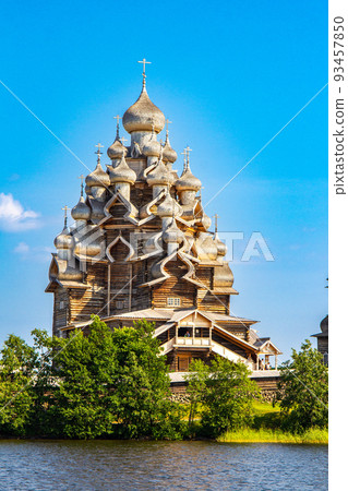 View to old monastery Kizhi Pogost, wooden Temple and Churchyard. Church of Transfiguration, bell tower in summer at sunset. Natural ecological clean island in Onega lake, Republic of Karelia, Russia 93457850
