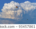 Parasailing over the sea, against the background of huge cumulus clouds. 93457861