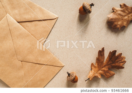 Fall background with paper envelope and oak leaves, autumn flat lay, copy space 93461666