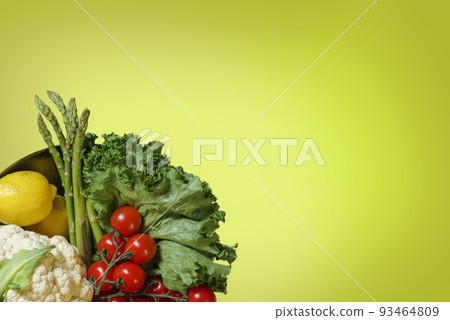 Bowl of fresh organic vegetables, salad, cauliflower, tomato, lemon, asparagus , carrot on yellow background with copy space, Healsy food concept Bowl of fresh organic vegetables, salad, cauliflower, tomato, lemon, asparagus , carrot on yellow background with copy space, Healsy food concept 93464809