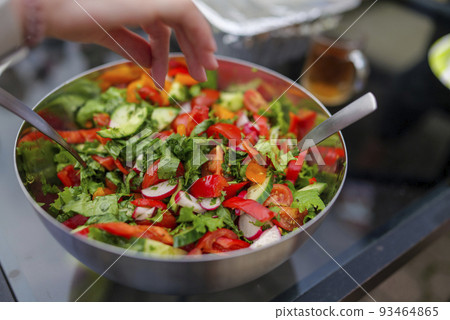 Selective focus of fresh chopped spring salad, man salt salad backyard, compilation of healthy food low calories food Selective focus of fresh chopped spring salad, man salt salad backyard, compilation of healthy food low calories food 93464865