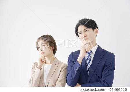 Business woman and businessman thinking on a white background Business woman and businessman thinking on a white background 93466926