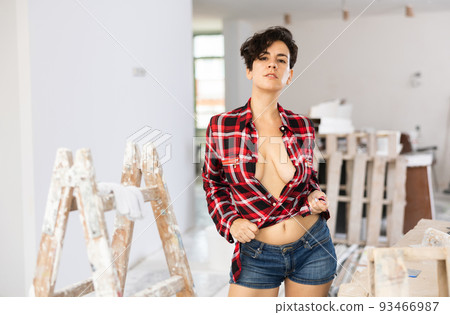 Playful topless girl in plaid shirt and shorts posing in cottage under construction Playful topless girl in plaid shirt and shorts posing in cottage under construction 93466987