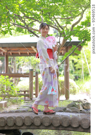 A woman wearing a yukata walking on a bridge 3 A woman wearing a yukata walking on a bridge 3 93469518