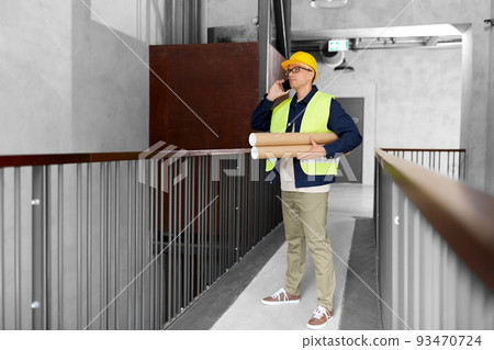 male architect with blueprint calling on phone male architect with blueprint calling on phone 93470724