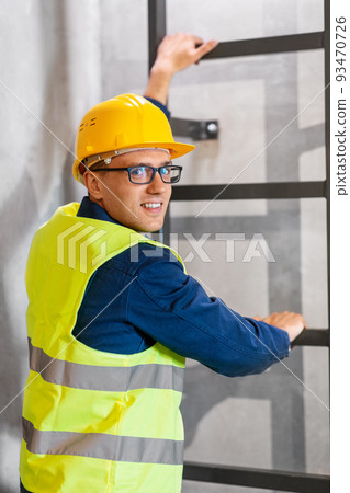 architect in helmet and goggles climbing stairs architect in helmet and goggles climbing stairs 93470726