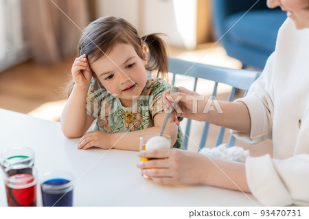 mother with child dyeing easter eggs at home mother with child dyeing easter eggs at home 93470731