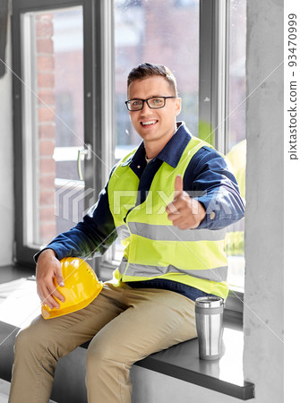 happy builder with tumbler showing thumbs up happy builder with tumbler showing thumbs up 93470999
