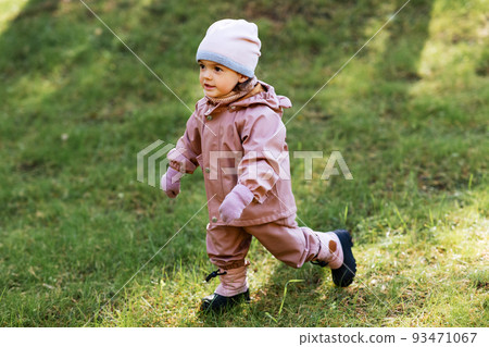 happy little baby girl walking in autumn park happy little baby girl walking in autumn park 93471067
