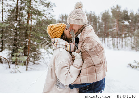 happy smiling couple touching noses in winter happy smiling couple touching noses in winter 93471116