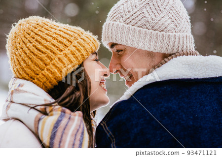 happy smiling couple touching noses in winter happy smiling couple touching noses in winter 93471121
