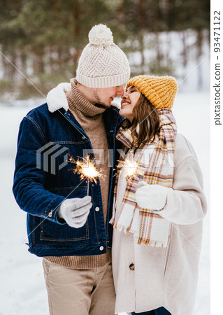 happy couple with sparklers in winter forest happy couple with sparklers in winter forest 93471122