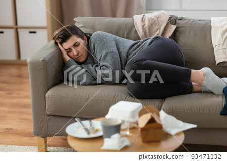 depressed woman lying on sofa at home 93471132