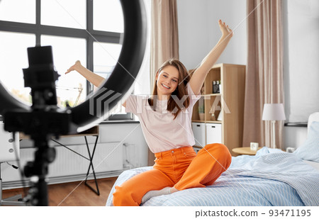 girl blogger with ring light streaming at home 93471195