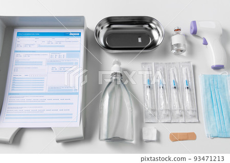 syringes, mask, sanitizer and other stuff on table 93471213