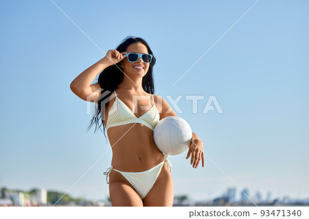 woman in bikini posing with volleyball on beach woman in bikini posing with volleyball on beach 93471340