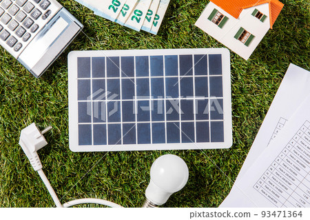solar battery, bulb, plug, coins and house model solar battery, bulb, plug, coins and house model 93471364