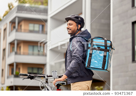 food delivery man with bag and bicycle in city 93471367