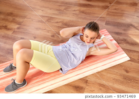 happy teenage girl exercising on yoga mat at home happy teenage girl exercising on yoga mat at home 93471469