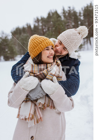 happy smiling couple hugging in winter park happy smiling couple hugging in winter park 93471515
