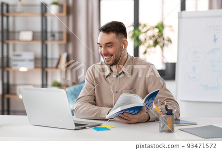 teacher with laptop having online class at home 93471572