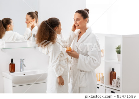 mother and daughter with moisturizer at bathroom mother and daughter with moisturizer at bathroom 93471589
