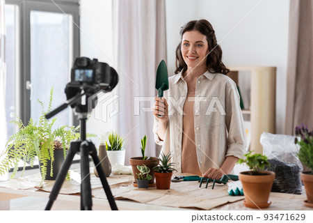 happy woman or blogger planting flowers at home happy woman or blogger planting flowers at home 93471629