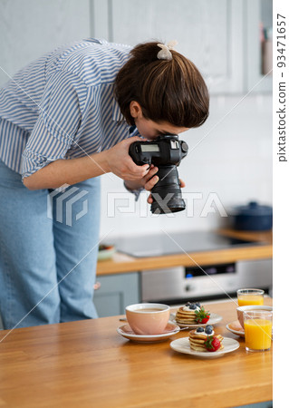 food photographer with camera working in kitchen food photographer with camera working in kitchen 93471657
