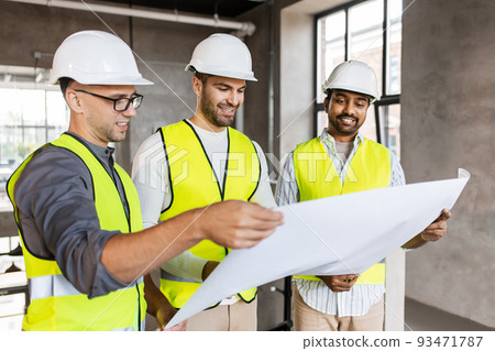 architects in helmets with blueprint at office architects in helmets with blueprint at office 93471787