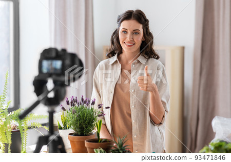 happy woman or blogger planting flowers at home 93471846