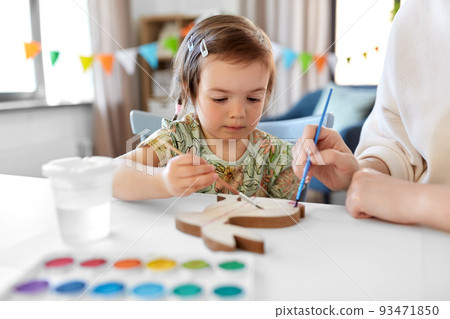 mother with child coloring easter bunny at home 93471850