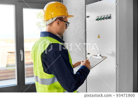 electrician with clipboard at electric board electrician with clipboard at electric board 93471900