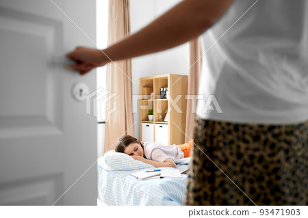 parent looking at student girl sleeping at home parent looking at student girl sleeping at home 93471903