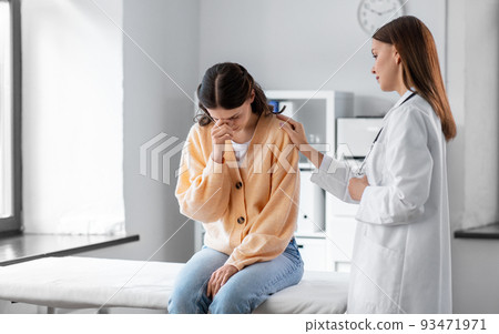 female doctor comforting sad woman at hospital female doctor comforting sad woman at hospital 93471971