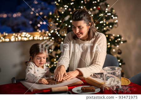 mother and daughter making gingerbread at home mother and daughter making gingerbread at home 93471975