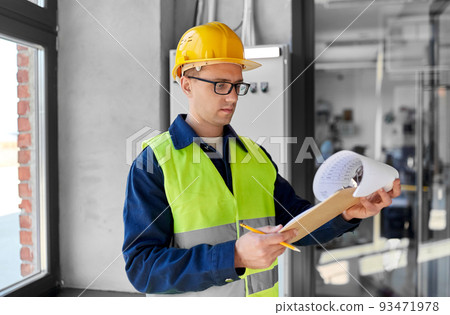 electrician with clipboard at electric board 93471978