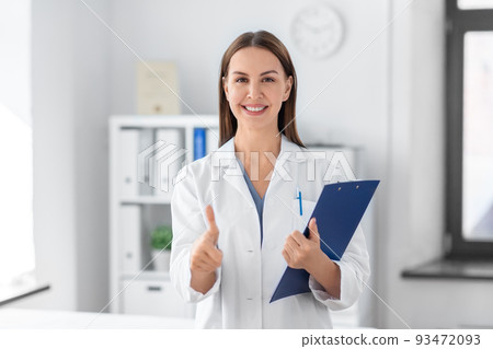 smiling female doctor with clipboard at hospital smiling female doctor with clipboard at hospital 93472093