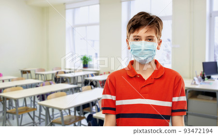 student boy in protective medical mask at school student boy in protective medical mask at school 93472194