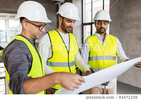 architects in helmets with blueprint at office architects in helmets with blueprint at office 93472256