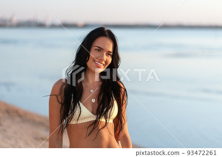 smiling young woman in bikini swimsuit on beach smiling young woman in bikini swimsuit on beach 93472261
