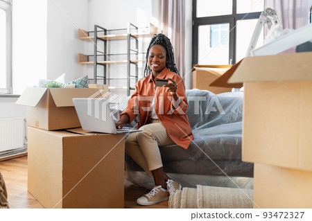 woman with laptop and credit card at new home woman with laptop and credit card at new home 93472327