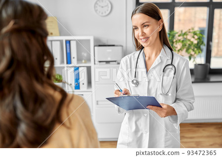 doctor with clipboard and woman at hospital doctor with clipboard and woman at hospital 93472365