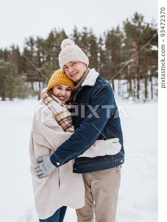 happy smiling couple hugging in winter park 93472370