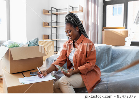 happy woman moving to new home and counting money happy woman moving to new home and counting money 93472379