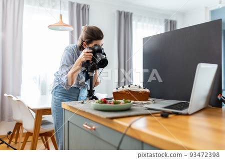 food photographer with camera working in kitchen food photographer with camera working in kitchen 93472398