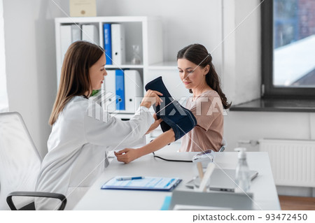 female doctor with tonometer and patient at clinic female doctor with tonometer and patient at clinic 93472450
