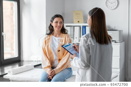 doctor with clipboard and woman at hospital doctor with clipboard and woman at hospital 93472700