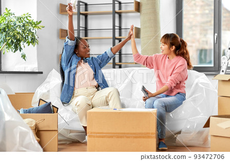 happy women moving to new home and counting money 93472706